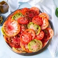 overlapping multicolored heirloom tomatoes on a bowl