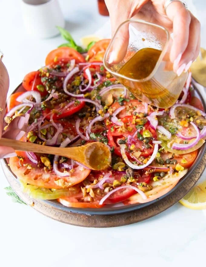 dressing or balsamic vinegar or olive oil only poured over the carpaccio