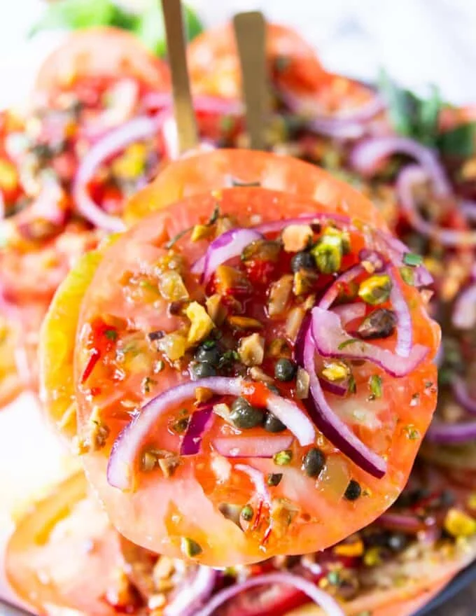 close up of one tomato carpaccio serving