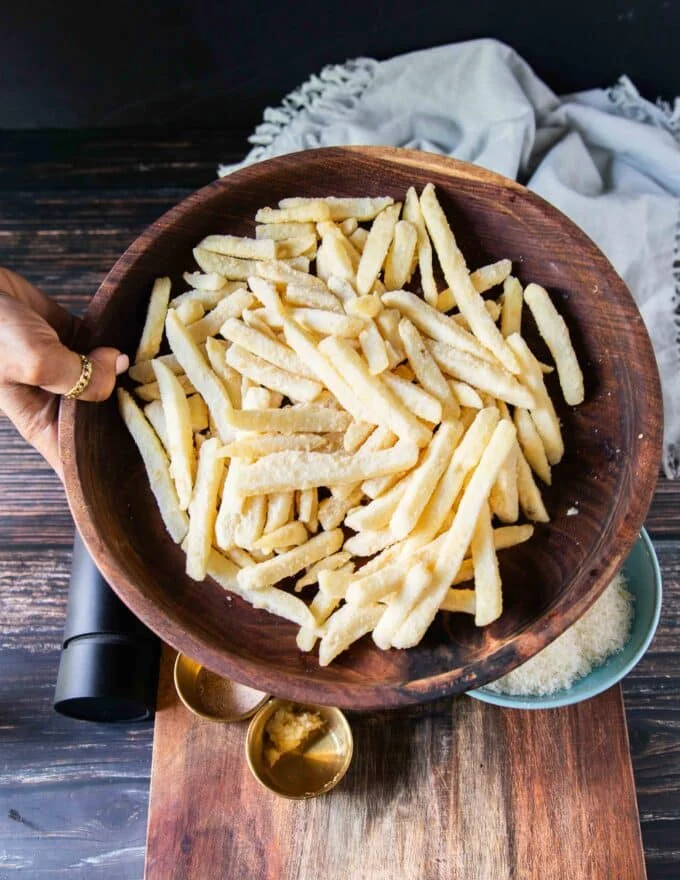 Frozen French Fries in a bowl or fresh potatoes to make french fries
