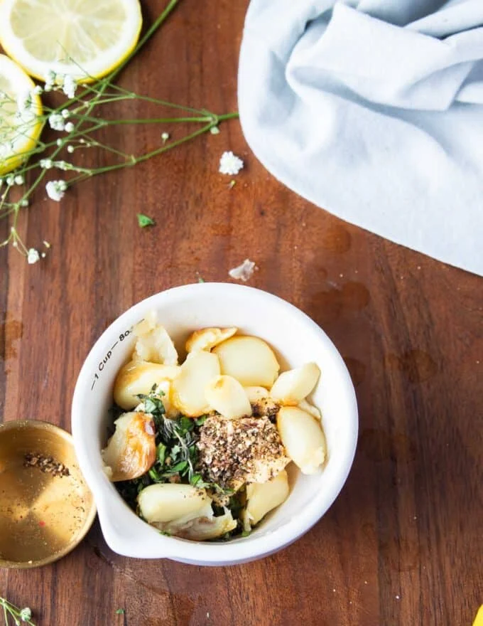 roast garlic, herbs and butter mixed together to make flavored butter