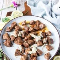 butter poured all over the air fryer steak bites