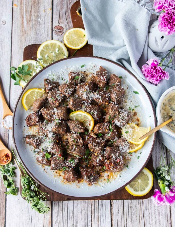 juicy air fryer steak bites with melted butter and parmesan