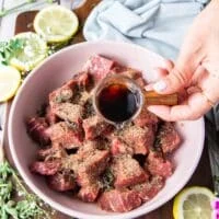 steak bites cut into 1 inch in a bowl with steak seasoning