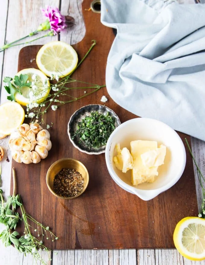 flavored butter ingredients with some roast garlic, herbs and seasoning