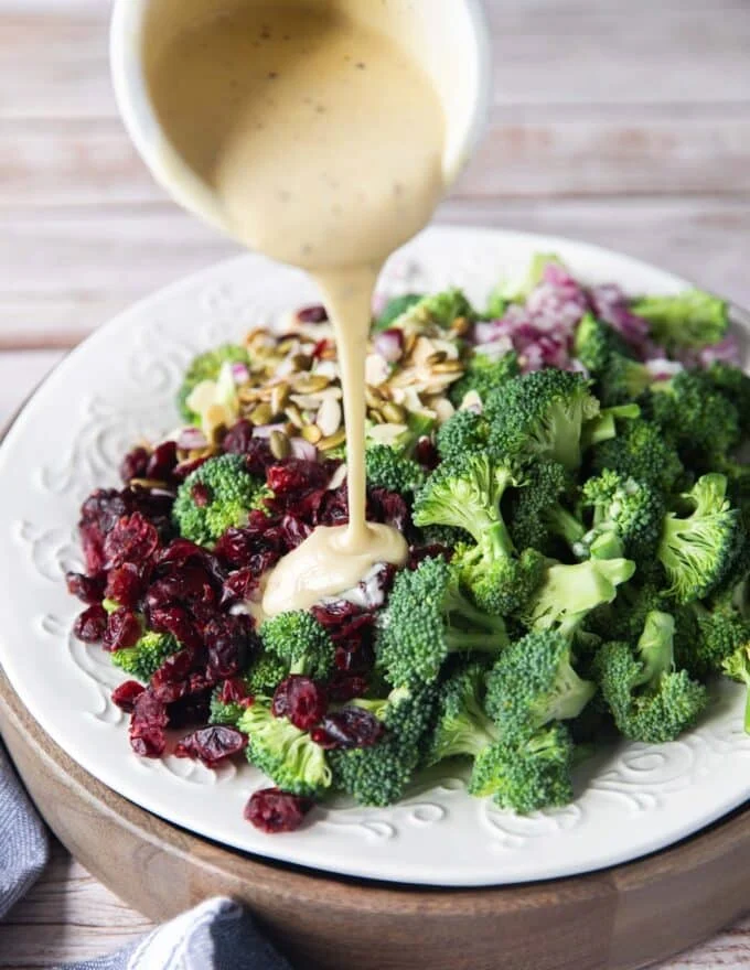 The creamy dressing poured over the broccoli salad ingredients