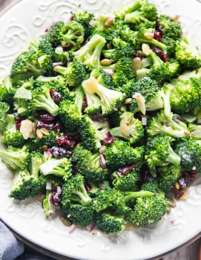 close up of creamy broccoli salad with cranberries sunflower seeds and nuts