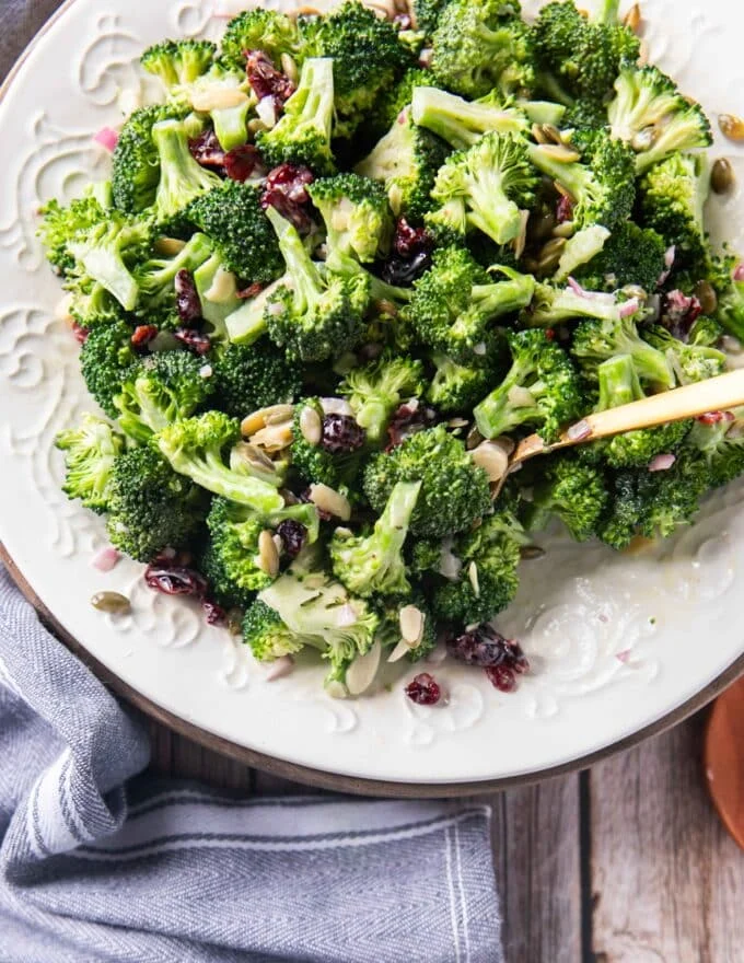 A full plate of creamy broccoli salad close up with a fork