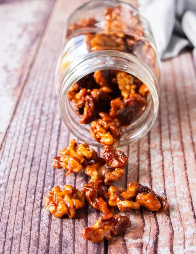 A close up of candied walnuts showing the clusters and glossy coat