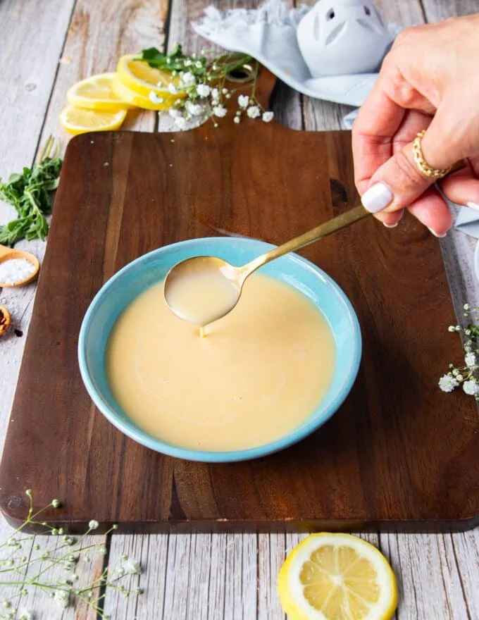 luscious creamy citrus beurre blanc with a spoon showing the silky texture