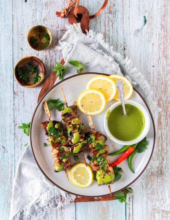 cooked halibut recipe on a plate with sauces to serve