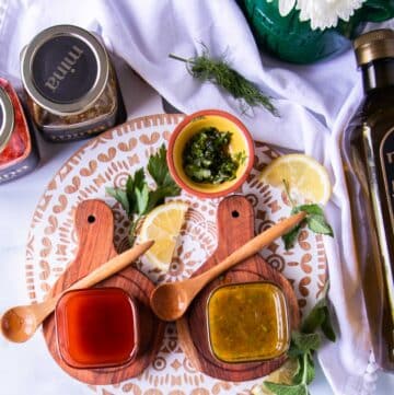 harissa vinaigrette in a bowl surrounded by salad