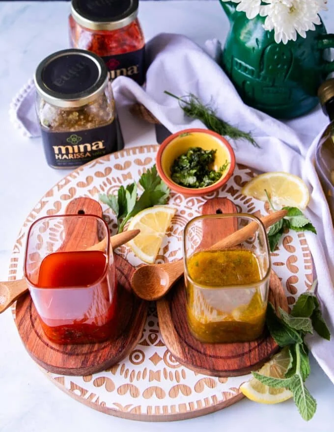 green and red harissa vinaigrette in two jars