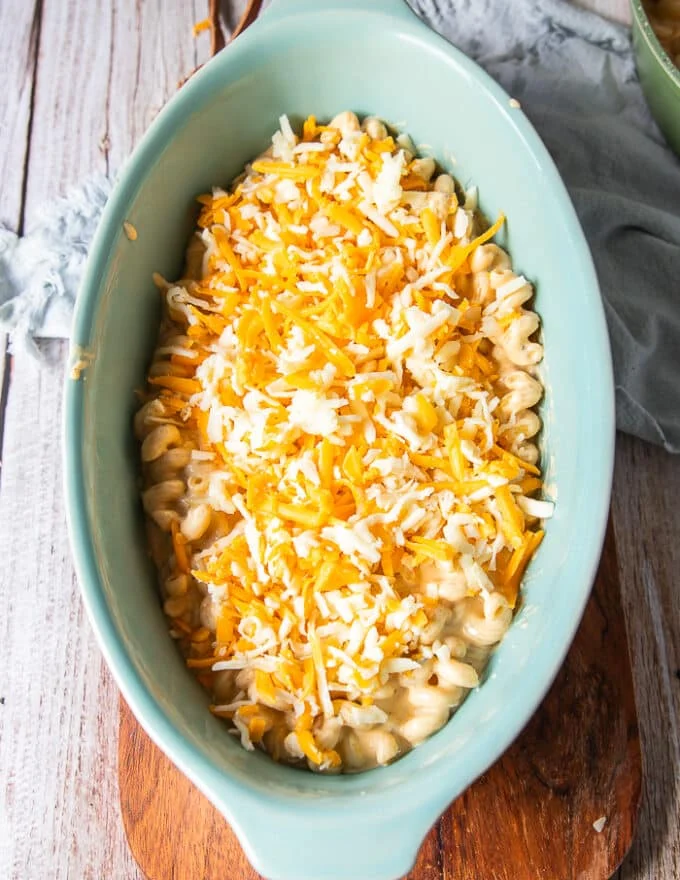 a layer of cheese is layered over half of the pasta