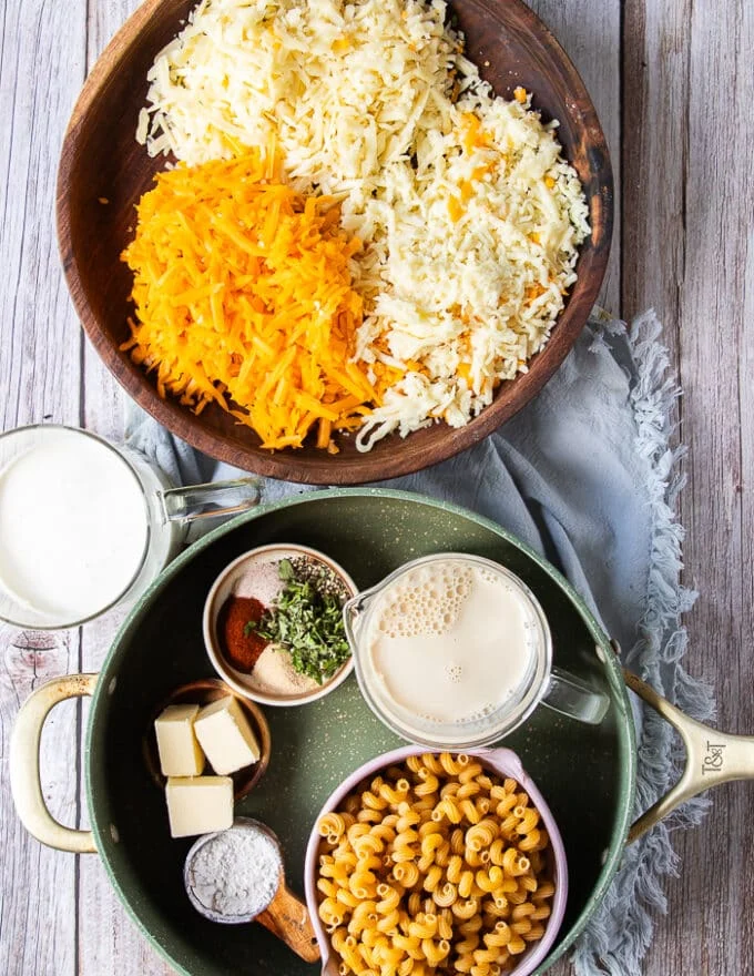 detailed mac and cheese recipe ingredients on a board each in a small bowl