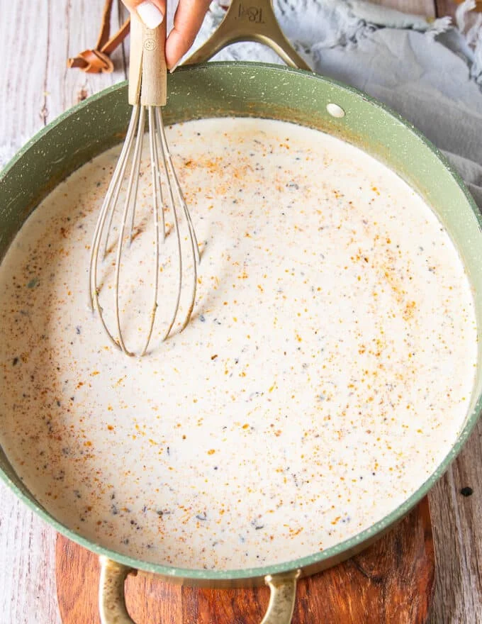 the cream and evaporated milk and seasoning added to the skillet
