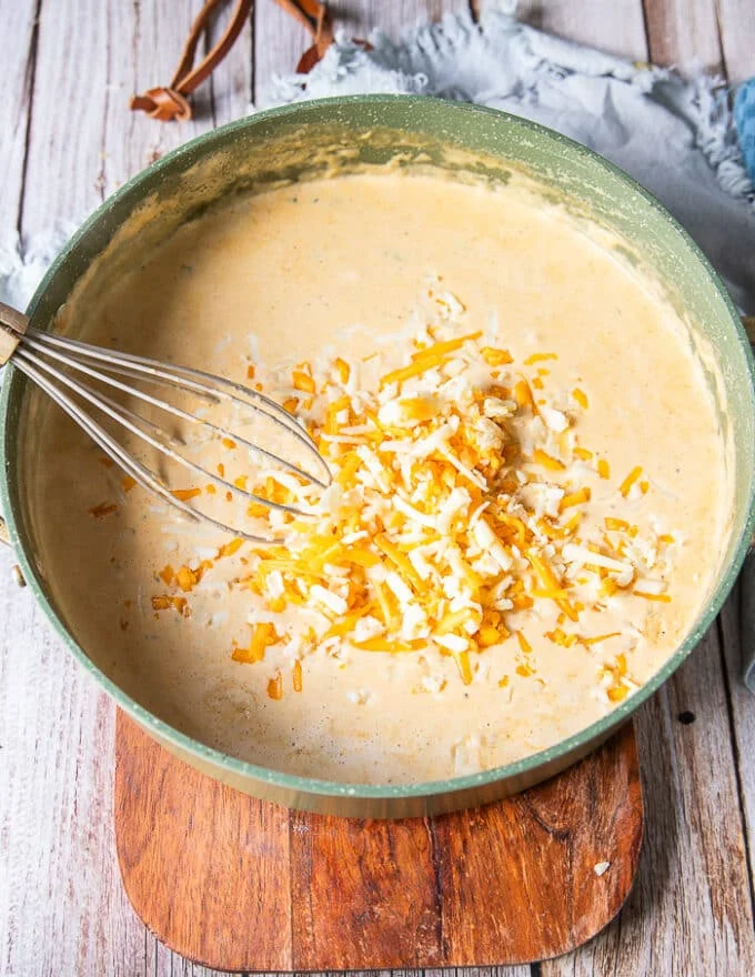 a third of the cheese is added to the bechamel sauce to make a cheesy sauce for mac and cheese
