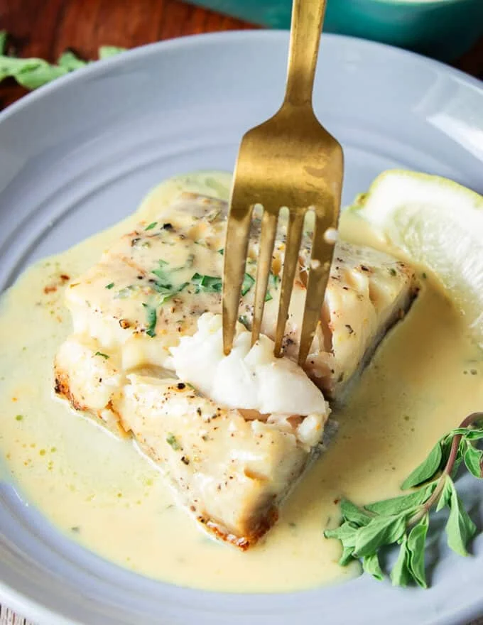 succulent flaky chilean sea bass with a fork showing how juicy it is