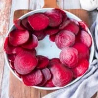Sliced beets arranged on a plate leaving the middle empty