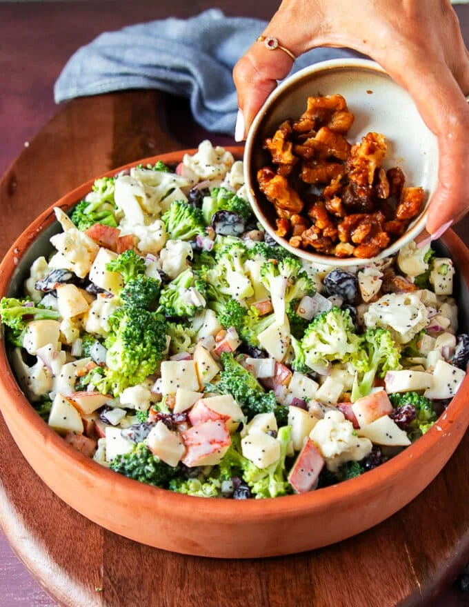 More candied walnuts is added over the top of the salad before serving