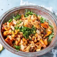 the tender roast cauliflower and crips chickpeas are added over the arugula, along with toasted almonds, herbs and raisins to make cauliflower salad