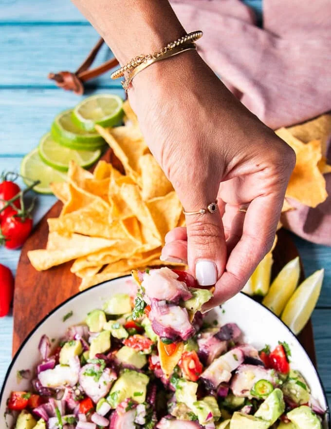close up of a tortilla chip loaded with octopus ceviche
