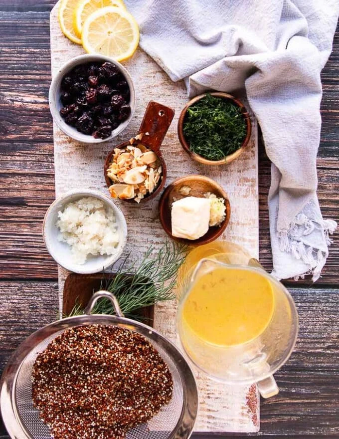 Ingredients to make quinoa pilaf on a board