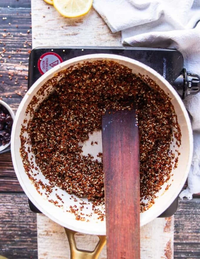 quinoa is toasting in the pan for flavor