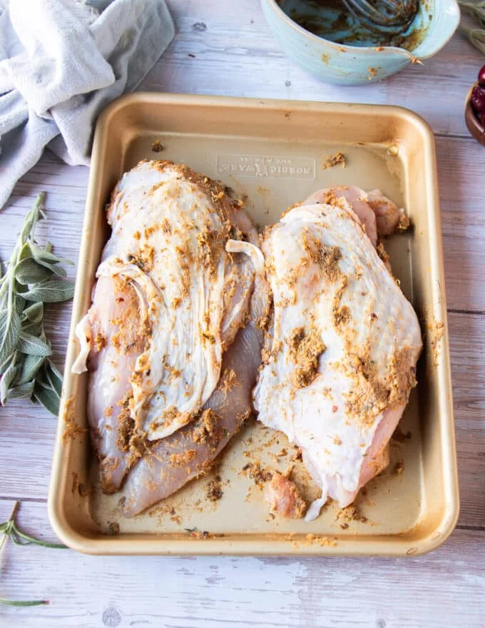 Fully slathered turkey breast with the butter mixture under the skin and everywhere