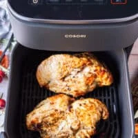 flipped turkey breast in an air fryer basket ready to conitnue cooking