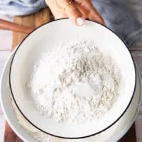 I cup of the dried flour mixture is removed on the side in a separate plate to dredge the fish in