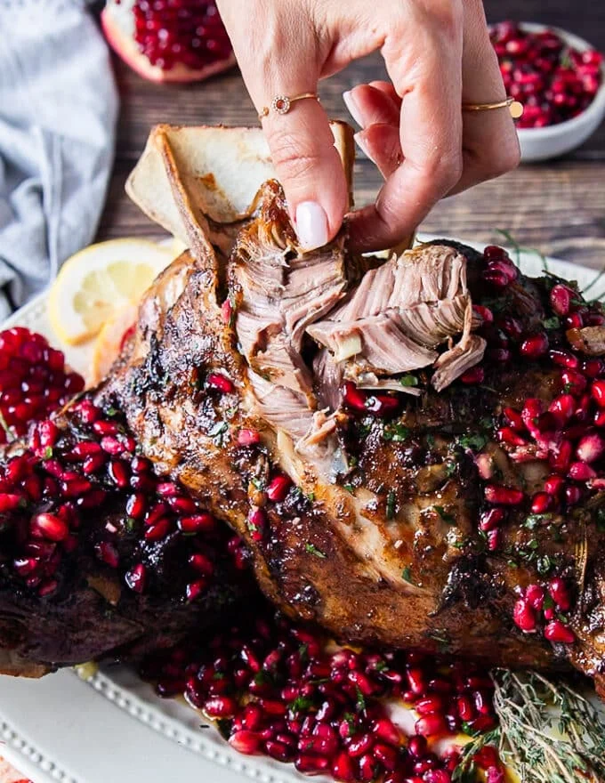 hand pulling apart the soft lamb meat