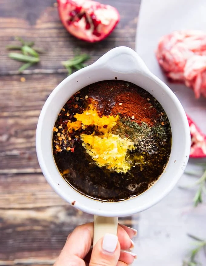 The balsalmic sauce is mixed in a bowl with citrus zests, olive oil and seasoning