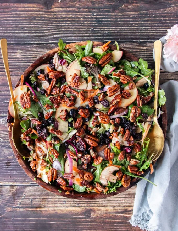 apple salad with greens apples maple vinaigrette and maple pecans in a bowl