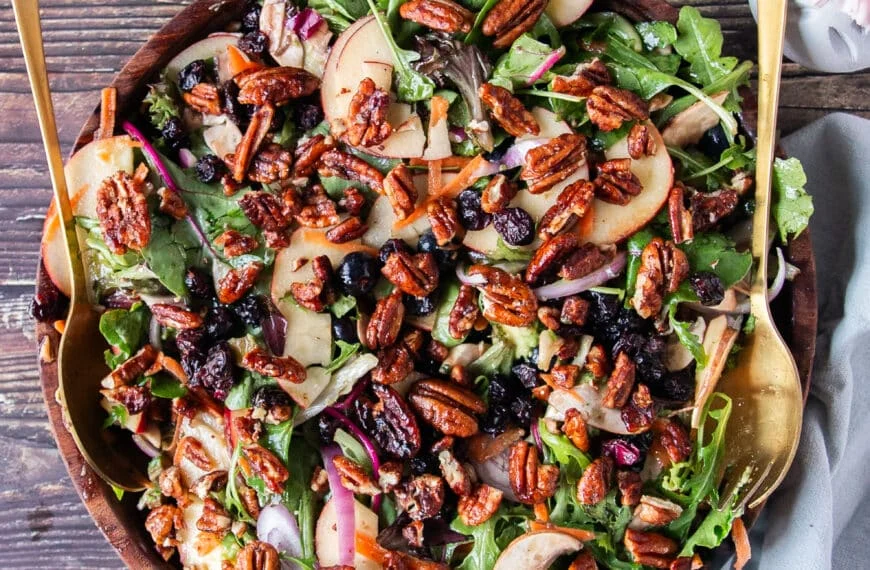 apple salad with greens apples maple vinaigrette and maple pecans in a bowl