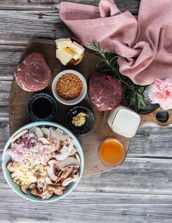Ingredients to make filet mignon recipe including center cut tenderloin, seasoning, butter, cream, mushrooms, Worcestershire sauce beef stock, cream, shallots and herbs