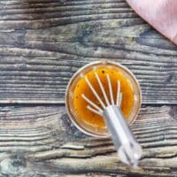 maple vinaigrette ingredients combined in a jar and whisk is used to emulsify