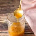 A spoon drizzling a maple vinaigrette showing consistency