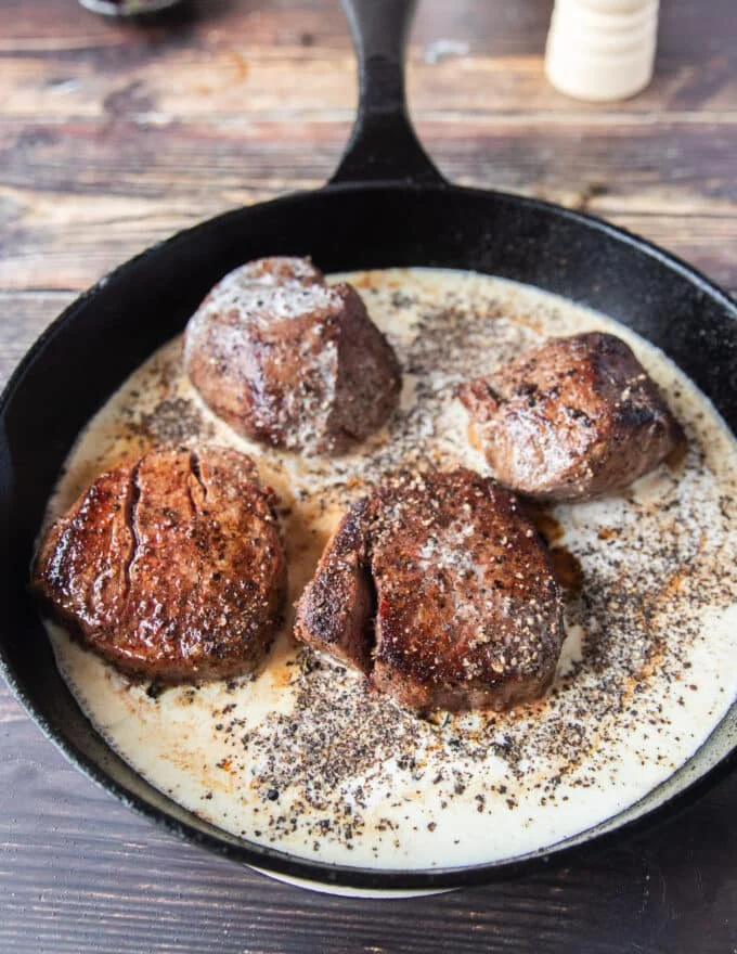 deglazing the steak drippings in the pan, adding dijon, Worcestershire , stock, peppercorns and seasoning to start the sauce