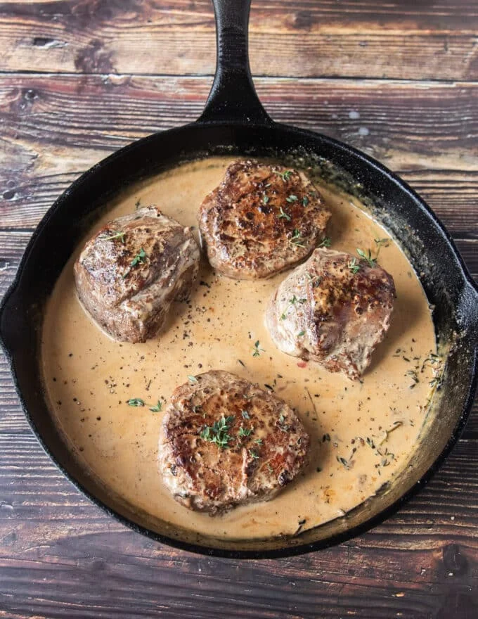 Cream is added after the sauce has simmered and reduced for the final creamy finish of the peppercorn steak sauce