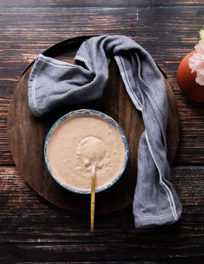 A bowl of taco sauce surrounded by a tea towel