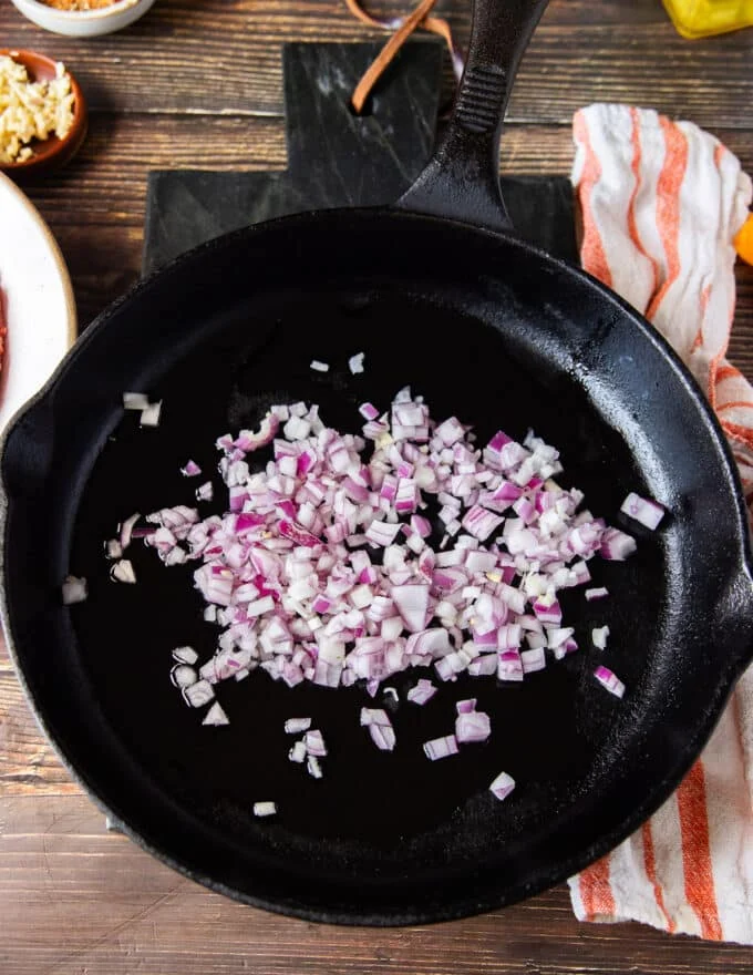 onions cooking in a hot skillet to prepare the beef mixture