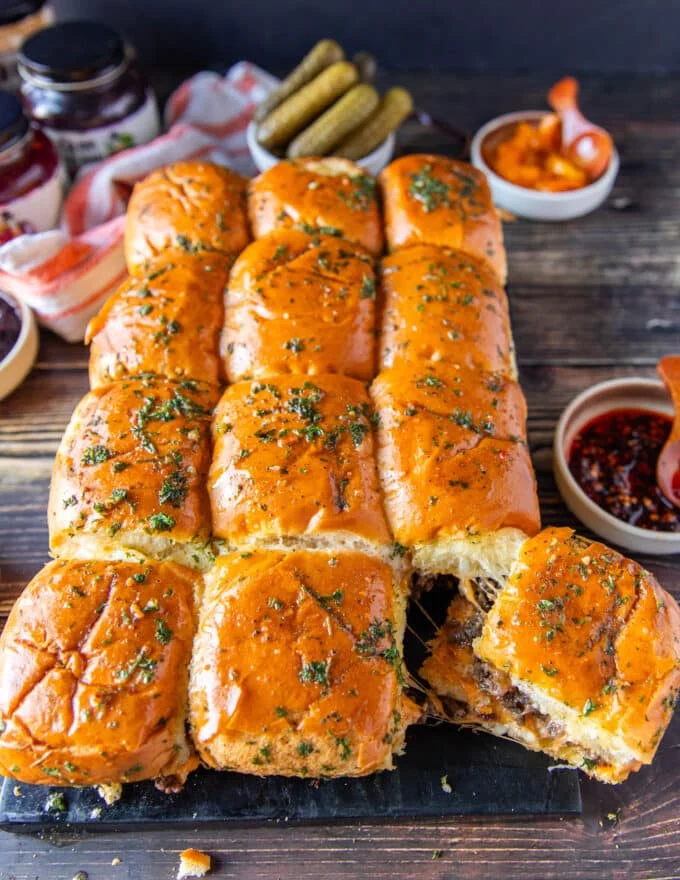 Cheeseburger sliders broken apart by hand to separate the buns