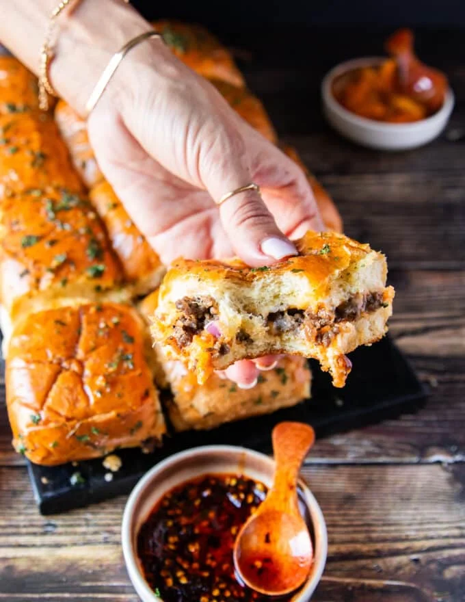 close up of a bitten slider showing how juicy the slider is and the melted cheese