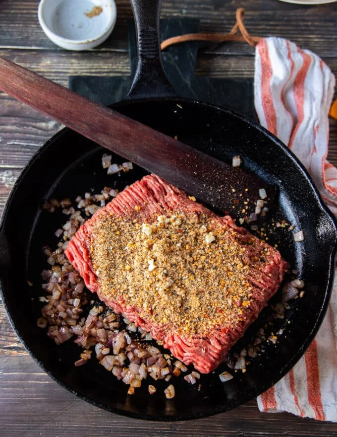 Meat is added with seasoning and garlic to cook well