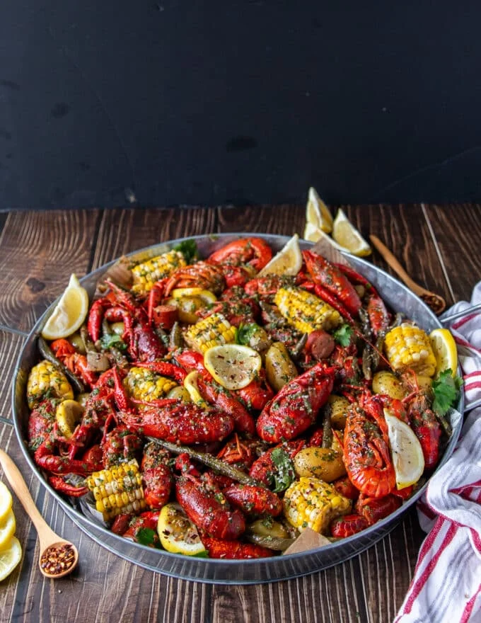 large platter of crawfish boil over newspaper