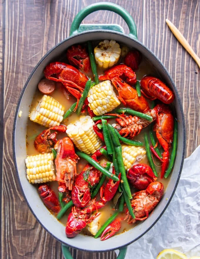 crawfish, corn and green beans are added to the pot