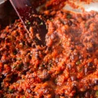 finished mexican black beans recipe is a pan and a close up showng the texture