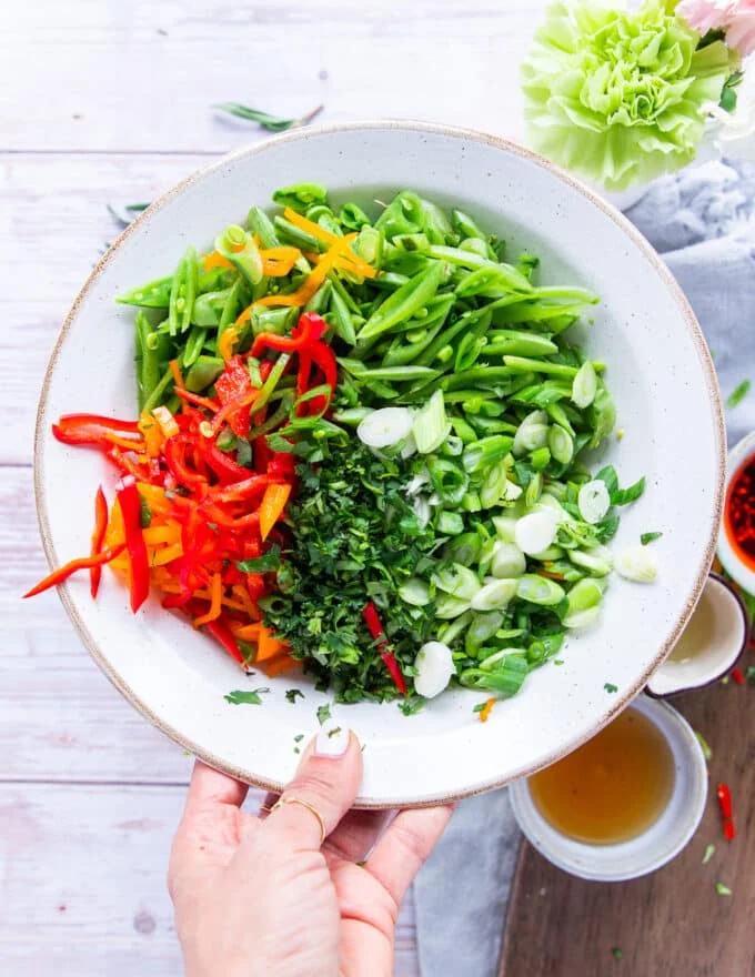 All the snap pea salad ingredients sliced and diced and added to a salad bowl