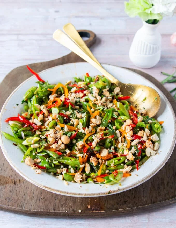 perfect snap pea salad all dressed up with crunchy nuts on top